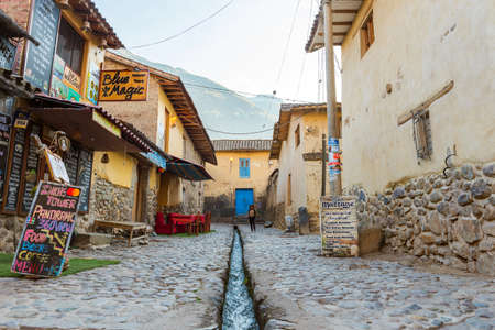 OLLANTAYTAMBO, PERU - JUNE 26, 2019: View of the city street with a water channelのeditorial素材