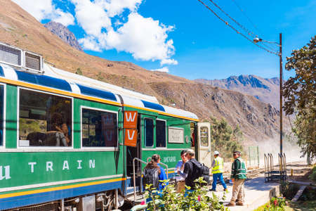 OLLANTAYTAMBO, PERU - JUNE 26, 2019: Tourists at the train station near the trainのeditorial素材