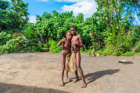 TANNA ISLAND, VANUATU - JULY 21, 2019: Boys in loincloths in the village of Yakelのeditorial素材