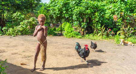 TANNA ISLAND, VANUATU - JULY 21, 2019: A boy in a loincloth in the village of Yakel. With selective focusのeditorial素材