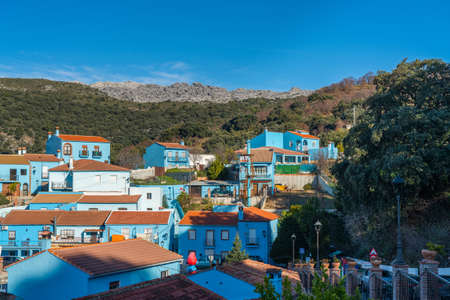 Juzcar, Spain - January 8, 2020: Buildings on a background of mountains in Juzcar blue town, Province of Malagaのeditorial素材