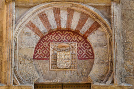 Coat of arms on the facade of the building Mosque Cathedral of Cordoba, Andalusia, Spainの写真素材