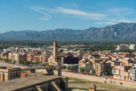 Tortosa, Spain - October 16, 2019: View of the bridge over the Ebro River and the church buildingのeditorial素材