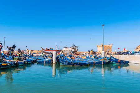 Essaouira, Morocco - November  17, 2019: View of Essaouira port with blue fishing boats. Copy space...
