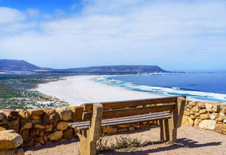 Bench on a background seascape, Hout Bay Beach, South Africa. Copy space for text                                                の写真素材