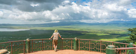 Tourist looks into the Ngorongoro crater National Park with the Lake Magadi from the look out.  Beautiful landscape scenery in Tanzania, Africaのeditorial素材