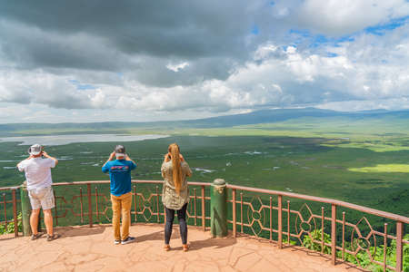 Tourist looking into the Ngorongoro Crater National Park with the Lake Magadi from the look out. Beautiful landscape scenery in Tanzania, Africaのeditorial素材