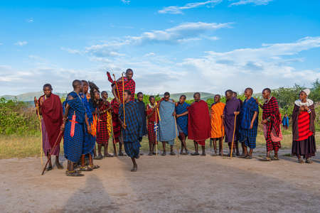 NGORONGORO, TANZANIA - February 15, 2020: Group of Massai People participating a traditional Dance with high Jumps, selected focus during Sunsetのeditorial素材