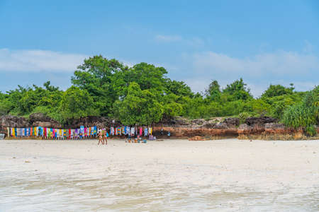Nungwi Beach, Zanzibar-Tanzania, February 12, 2020: Souvenirs at the tropical white Beach of Zanzibar Island. Tanzania. Eastern Africa, blue cloudy sky, copy spaceのeditorial素材