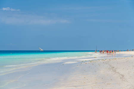 Zanzibar, Tanzania February 12.2020: Tropical White Beach of Zanzibar Island. Tanzania. People...