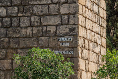 Street name sign on Plaza del Triunfo in Seville, Andalusia, Spain.
