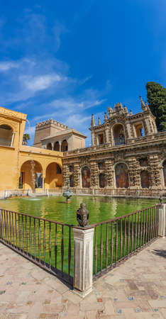 Gardens with fountain in historical Reales Alcazares in Seville in Andalusia, Spain, verticalのeditorial素材