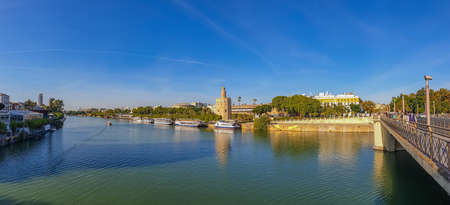 A panorama view of the Guadalquivir River and the Torre del Oro, in Seville, Spainのeditorial素材
