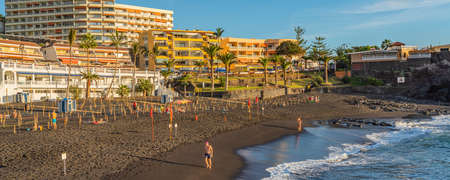 PUERTO DE SANTIAGO, SPAIN - NOVEMBER 09.2020: Playa de la Arena is a beach with black volcanic sand during sunset in Puerto de Santiago, Tenerife, Spain panorama viewのeditorial素材