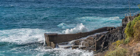 Atlantic ocean with turquoise water, breaking waves on a rocks on Tenerife, Canary Islandの写真素材