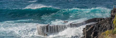 Atlantic ocean with turquoise water, breaking waves on a rocks on Tenerife, Canary Islandの写真素材