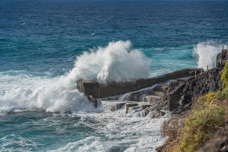 Atlantic ocean with turquoise water, breaking waves on a rocks on Tenerife, Canary Islandの写真素材