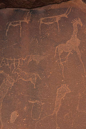 KHORIXAS, NAMIBIA - January 13.2021: Prehistoric Bushman engravings, rock painting at Twyfelfontein, Namibia - Plate with round symbols for waterholes on a rockのeditorial素材