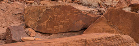KHORIXAS, NAMIBIA - January 13.2021: Prehistoric Bushman engravings, rock painting at Twyfelfontein, Namibia - Plate with round symbols for waterholes on a rockのeditorial素材