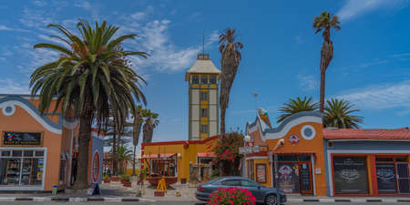 SWAKOPMUND, NAMIBIA - JAN 11, 2020: Promenade in Swakopmund with palm trees and people have rest at the walkingwayのeditorial素材