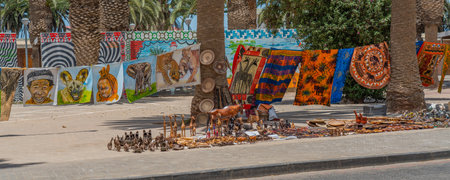 SWAKOPMUND, NAMIBIA - JAN 11, 2020: Promenade in Swakopmund with palm trees and people have rest at the walkingwayのeditorial素材