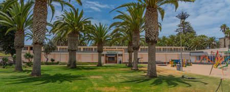 SWAKOPMUND, NAMIBIA - JAN 11, 2020: Promenade in Swakopmund with palm trees and people have rest at the walkingwayのeditorial素材