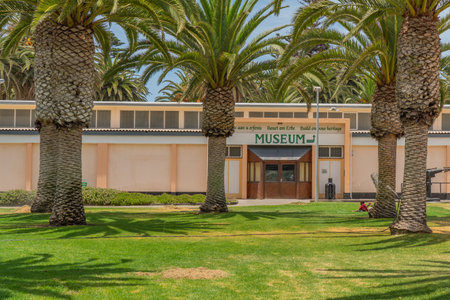 SWAKOPMUND, NAMIBIA - JAN 11, 2020: Promenade in Swakopmund with palm trees and people have rest at the walkingwayのeditorial素材