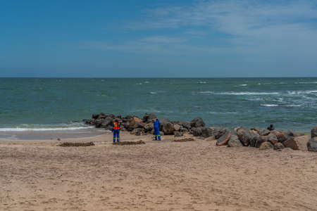 SWAKOPMUND, NAMIBIA - JAN 11, 2020: Promenade in Swakopmund with palm trees and people have rest at the walkingwayのeditorial素材
