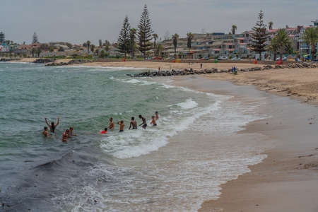 SWAKOPMUND, NAMIBIA - JAN 11, 2020: Promenade in Swakopmund with palm trees and people have rest at the walkingwayのeditorial素材