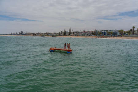 SWAKOPMUND, NAMIBIA - JAN 11, 2020: Promenade in Swakopmund with palm trees and people have rest at the walkingwayのeditorial素材