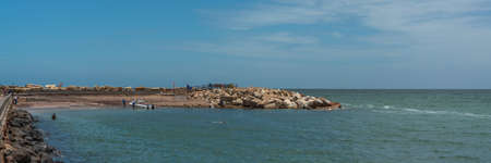SWAKOPMUND, NAMIBIA - JAN 11, 2020: Promenade in Swakopmund with palm trees and people have rest at the walkingwayのeditorial素材
