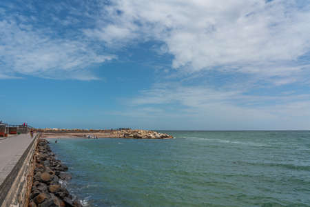 SWAKOPMUND, NAMIBIA - JAN 11, 2020: Promenade in Swakopmund with palm trees and people have rest at the walkingwayのeditorial素材