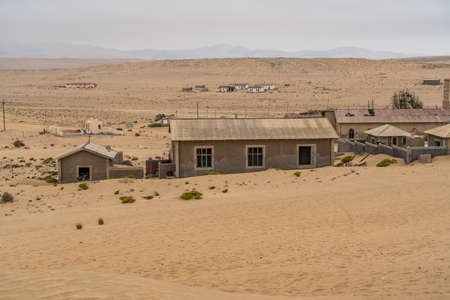 German Kolmanskop - Kolmannskuppe Ghost Town in Namibia with the abandoned buildings in the Namib...