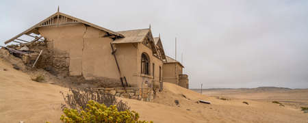 German Kolmanskop - Kolmannskuppe Ghost Town in Namibia with the abandoned buildings in the Namib...