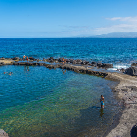 SANTO ANTONIO, PORTUGAL AUGUST 28, 2020: Rocky natural pool at the coast in Santo Antonio, Sao Miguel Island, Azores, Portugal, people swimmingのeditorial素材