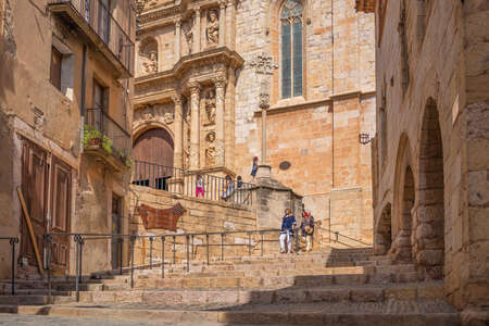MONTBLANC, SPAIN - SEPTEMBER 12.2021: Steps to the church with people in the historic quarter of the antique Spanish village Montblanc. Cataloniaのeditorial素材