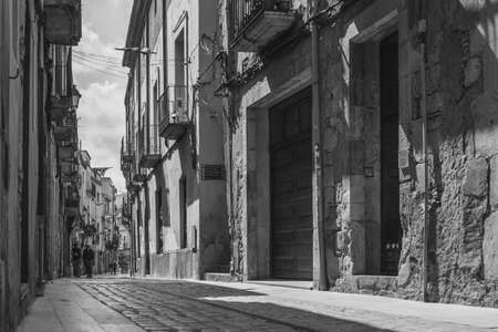 MONTBLANC, SPAIN - SEPTEMBER 12th 2021: Black and white vintage picture of a small street with old buildings in Spainのeditorial素材