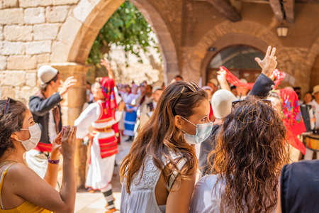 Street view with womens in mask at the Mayor folk festival in Montblanc, village on Tarragona, Cataloniaのeditorial素材