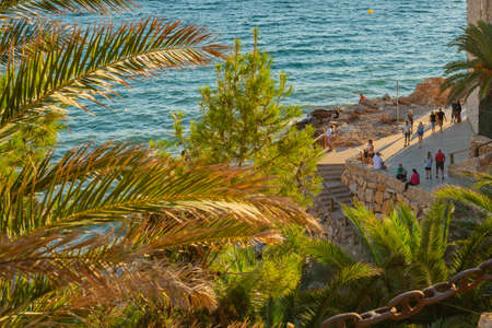 SALOU, SPAIN - SEPTEMBER 19.2021: Coastline Costa Dorada, Promenada at Salou with people, sunset at Summertimeのeditorial素材