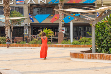 SANTA MARIA, CAPE VERDE, - JUNE 20.2022: Street view with a woman in red dress on Sal Island, Cape Verdeのeditorial素材