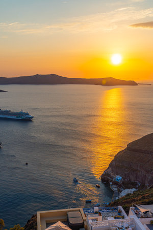 FIRA, GREECE - MAY 21.2022: Sunset view to the sea and Volcano from Fira the capital of Santorini island, verticalのeditorial素材