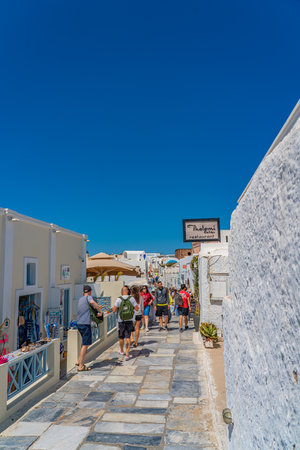 OIA, GREECE - MAY 22.2022: Souvenir shops of Oia with traditional white houses, Santorini island, Greeceのeditorial素材