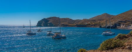 SANTORINI, GREECE - MAY 22.2022: Beautiful scenery of boats at red sand beach in Akrotiri village on Santorini, Greece, panoramaのeditorial素材
