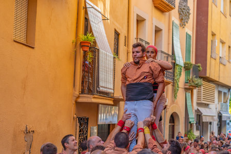 CAMBRILS, SPAIN - SEPTEMBER 04.2022: Castells Performance, a castell is a human tower built traditionally in festivals within Tarragona, Cataloniaのeditorial素材