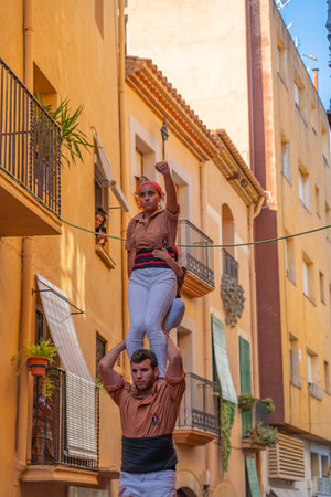 CAMBRILS, SPAIN - SEPTEMBER 04.2022: Castells Performance, a castell is a human tower built traditionally in festivals within Tarragona, Cataloniaのeditorial素材