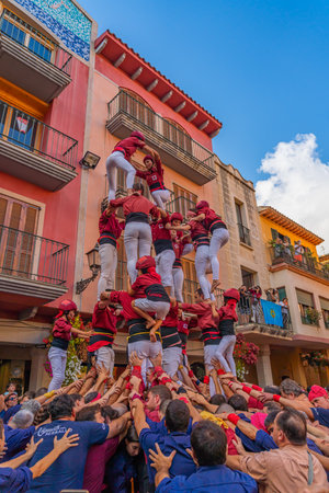 CAMBRILS, SPAIN - SEPTEMBER 04.2022: Castells Performance, a castell is a human tower built traditionally in festivals within Tarragona, verticalのeditorial素材
