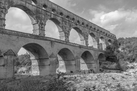 Pont du Gard three-tiered aqueduct, the bridge built in the first century AD on the river Gardon. Provence, black and whiteの写真素材