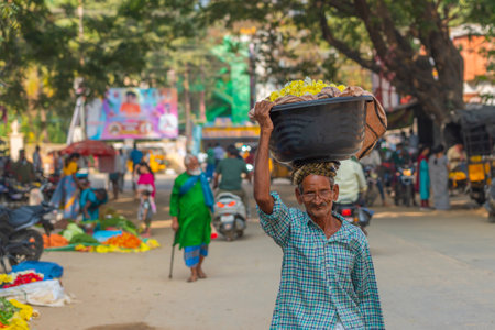 A man carry on the head a basket at a local Indian marketのeditorial素材