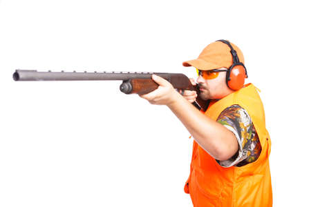 Hunter aiming a pump action shotgun, wearing safety camouflage clothing, isolated on white, 