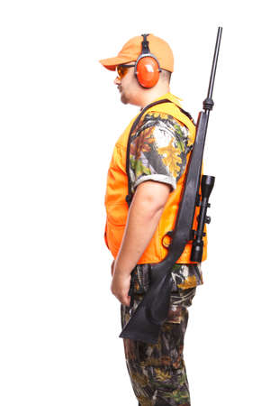 Left shoulder, Studio shot of hunter wearing camouflage clothing and holding a rifle, isolated on...